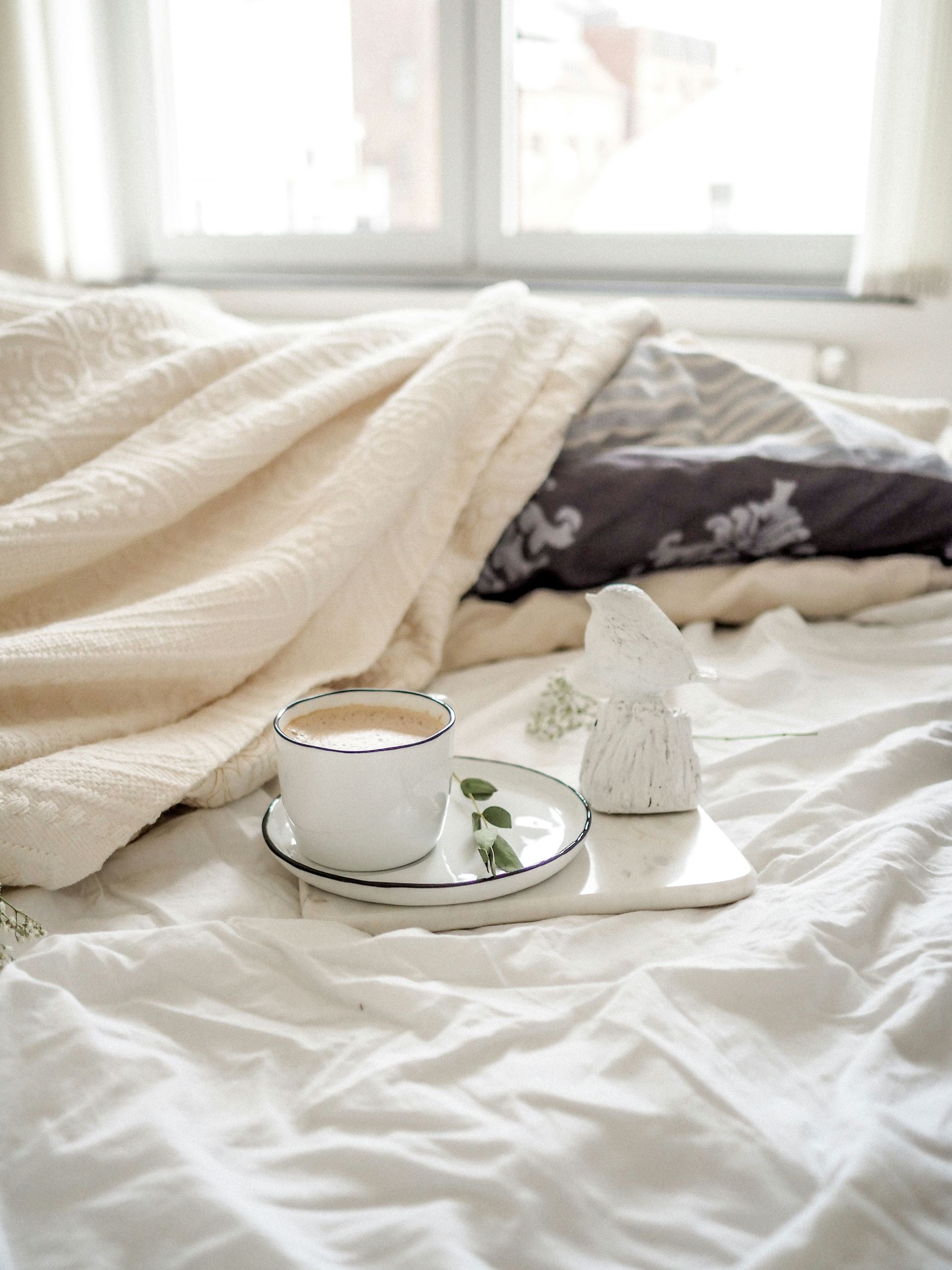Tea cup on a bed